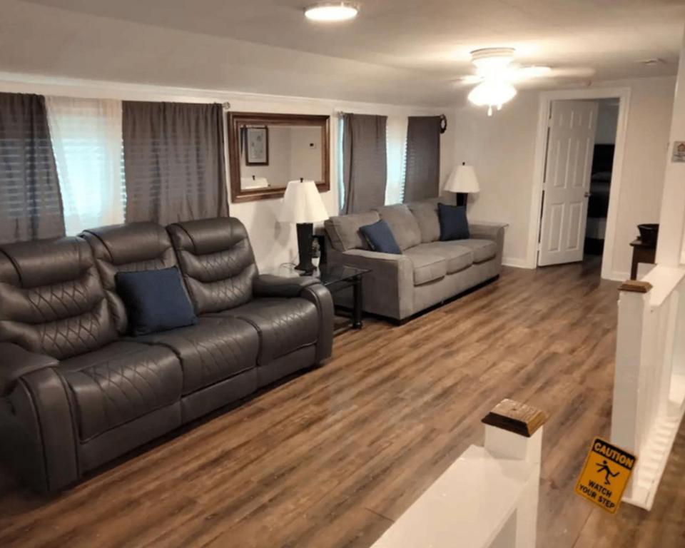a living room with a leather couch and couches at 3 Bed 3 Bath House, Conveniently close to everything, Smart Tvs in all rooms whole house to yourself in New Bern