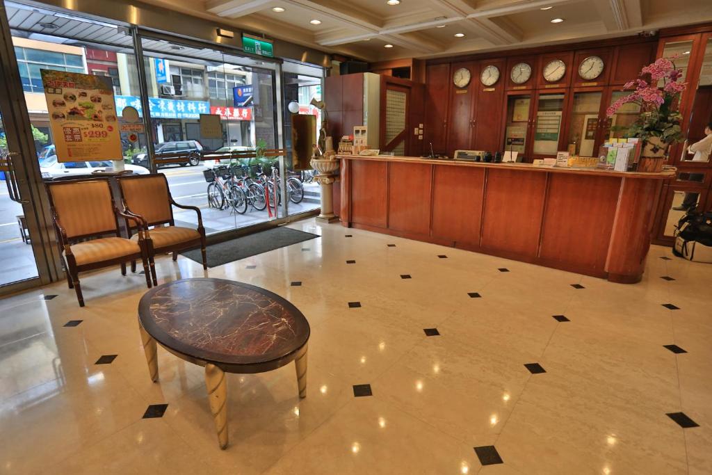 a lobby of a store with a table and a counter at Cambridge Tainan Hotel in Tainan