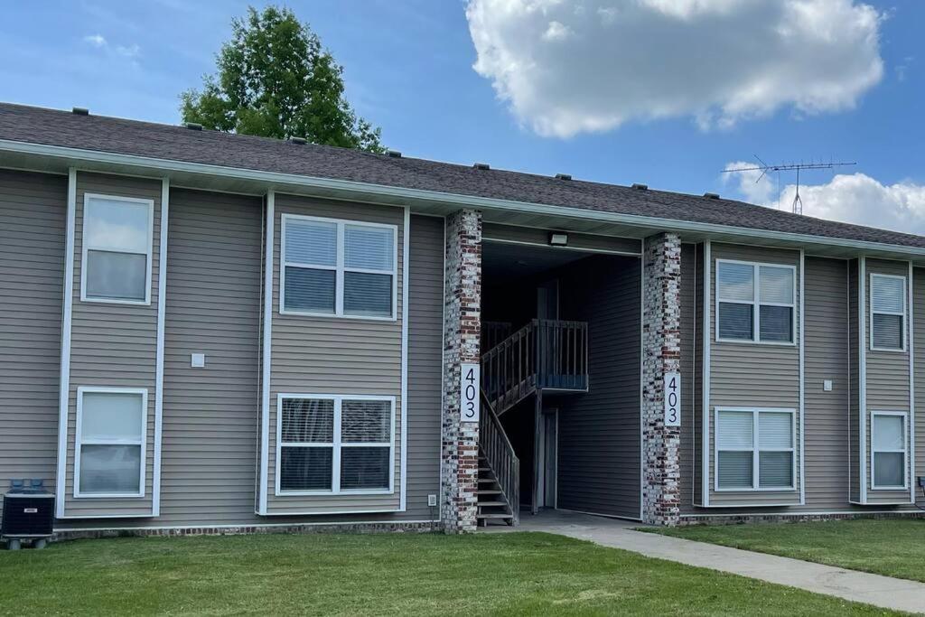 a brown house with a staircase in the garage at The Ingrid Apt #8 - Fresh and Simple 2bd with WiFi in Hamilton