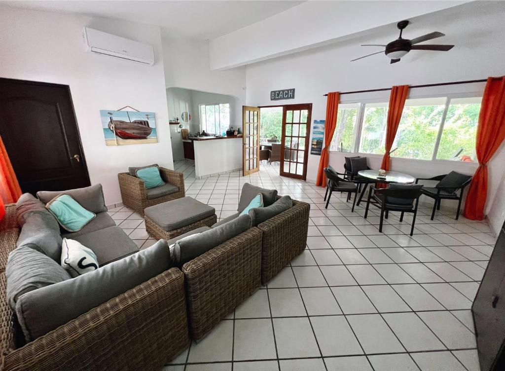 a living room with a couch and a table and chairs at Villa Montana in Contadora