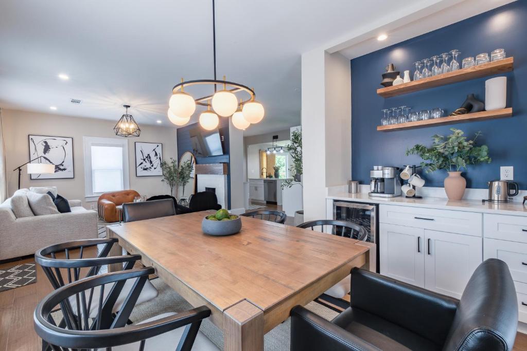 a kitchen and living room with a wooden table and chairs at Blue Haven ATL in Atlanta