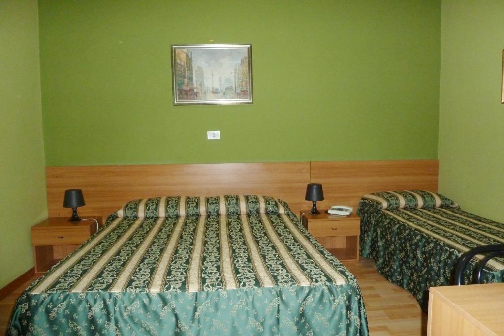 Postel nebo postele na pokoji v ubytování Hotel Sutrium