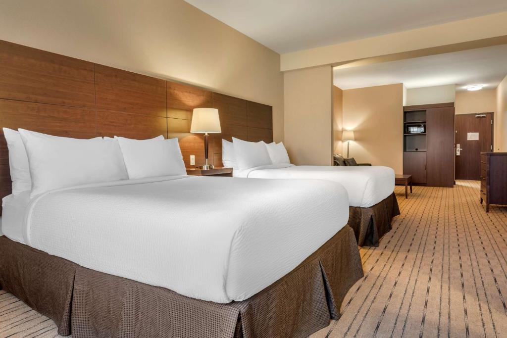 a hotel room with two large beds and a kitchen at Best Western Plus, Bathurst Hotel & Suites in Bathurst