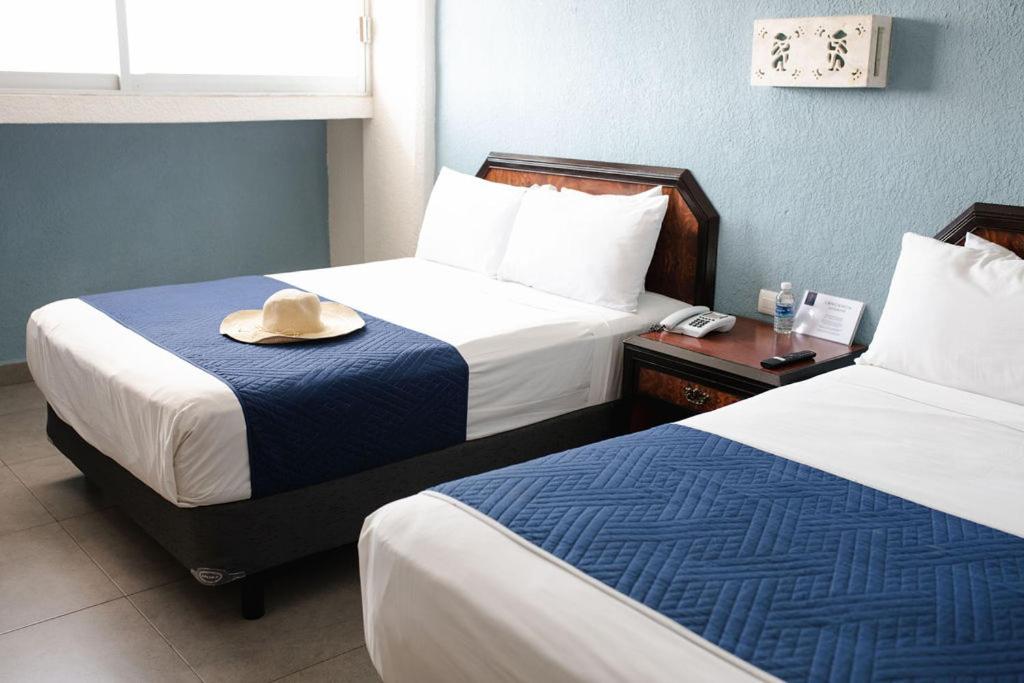 Postel nebo postele na pokoji v ubytování Hotel Los Aluxes