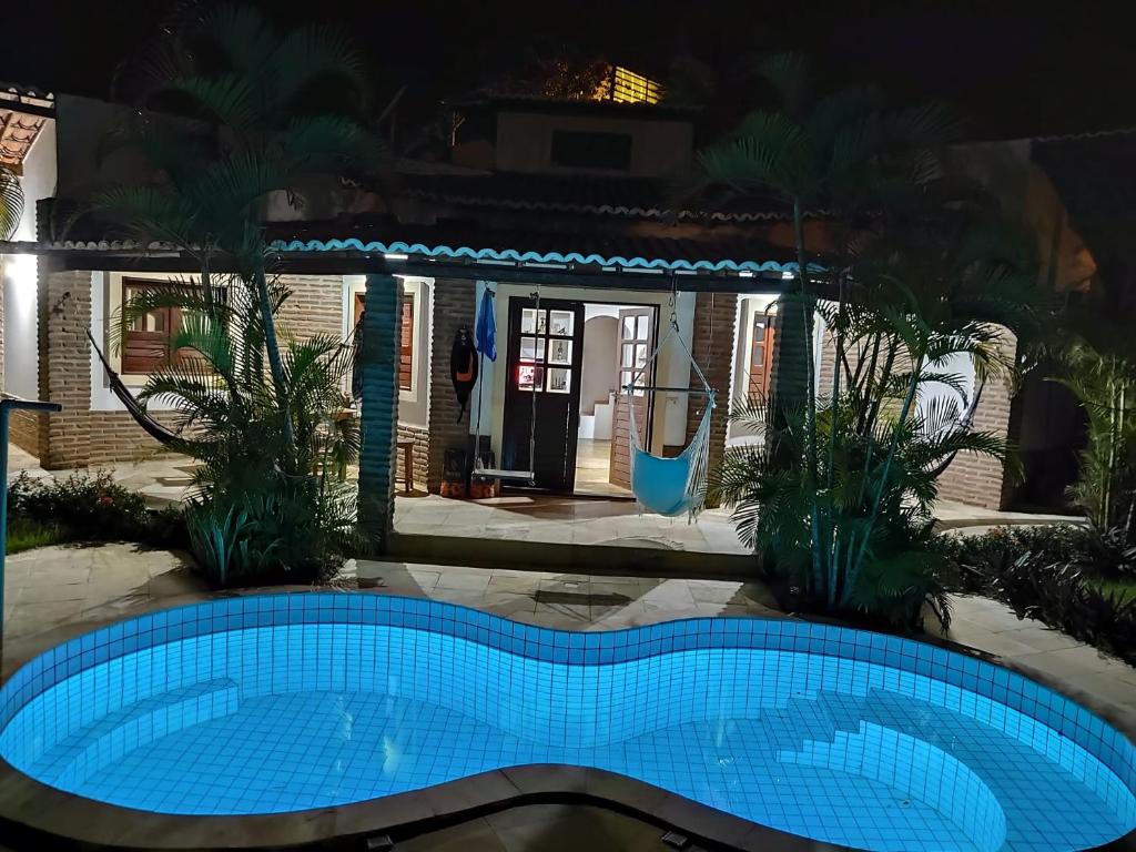 a swimming pool in front of a house at night at Casa Jeri in Jericoacoara
