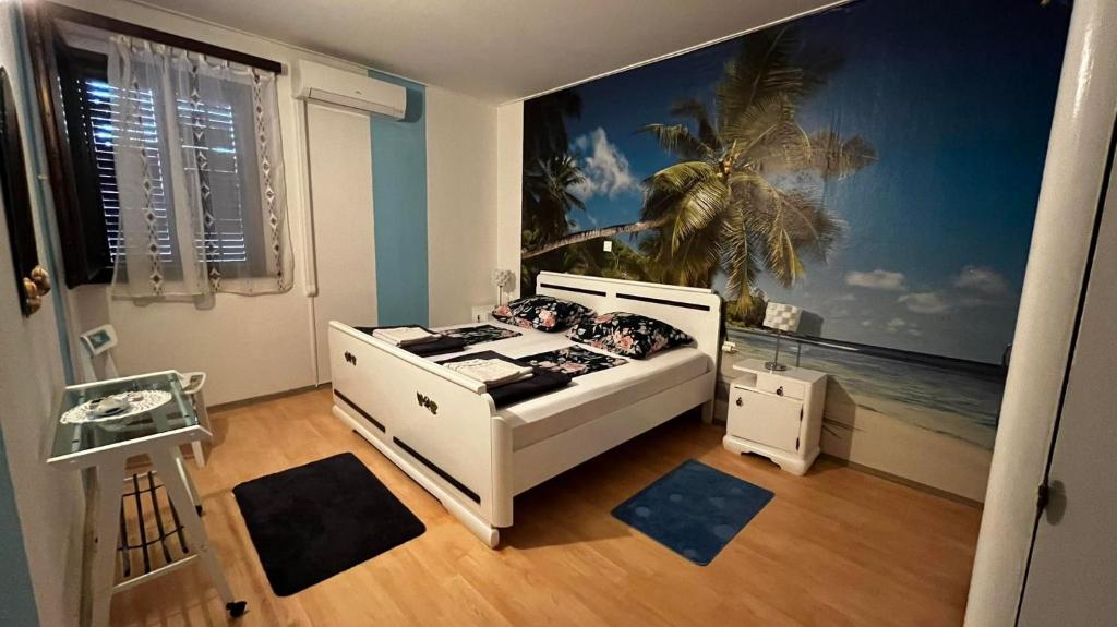 a bedroom with a white bed and a palm tree mural at Apartments by the sea Mali Losinj, Losinj - 19959 in Mali Lošinj