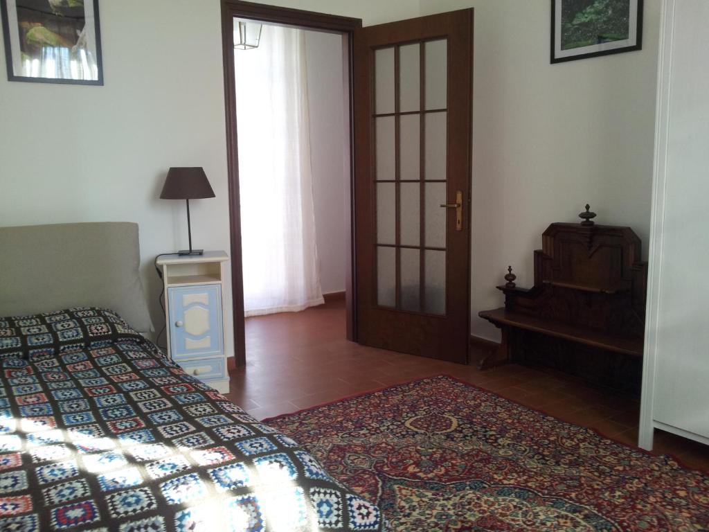 a bedroom with a bed and a table and a door at Bed and Breakfast Campel Inzago in Inzago