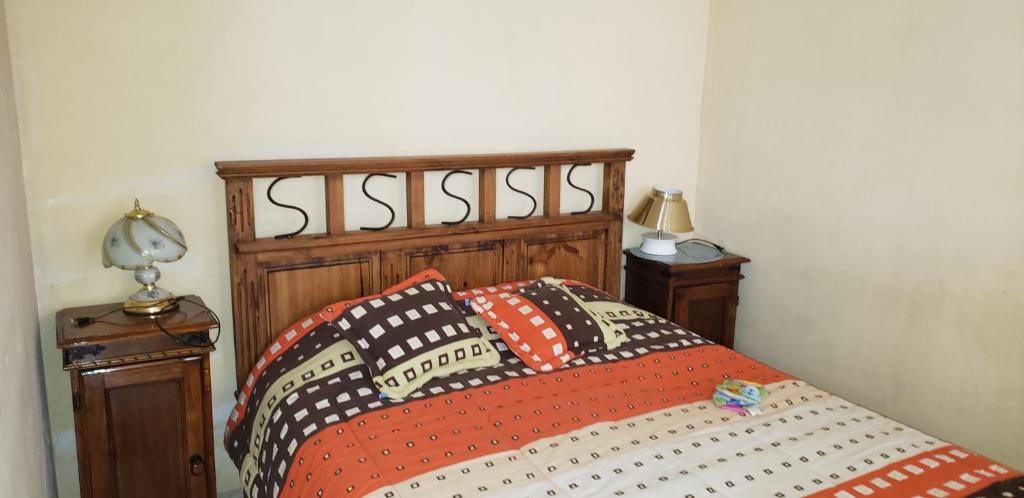 a bed with two pillows on it in a bedroom at Depto comodo centrico cerca a colegios;hospitales in Cochabamba