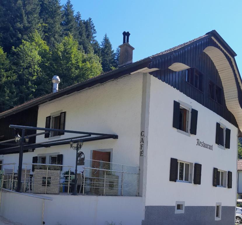 a white building with a black roof at Soubey (Clairbief) in Soubey