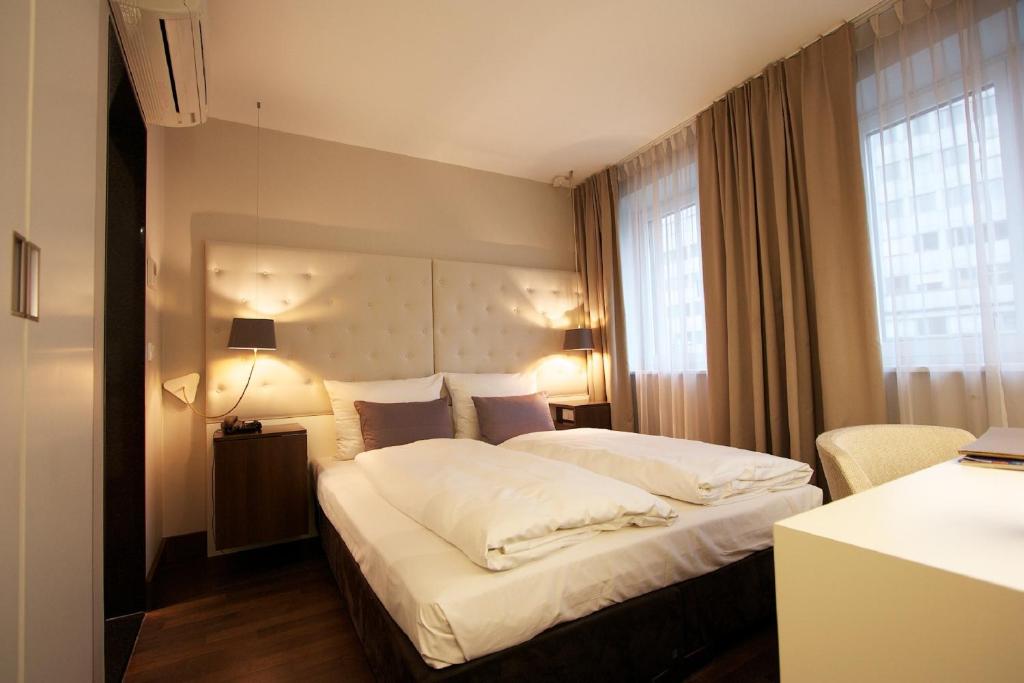 a bedroom with a large bed and a large window at Europa Style in Frankfurt/Main