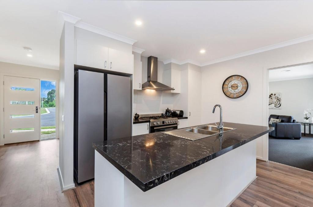 a kitchen with a sink and a counter top at Park View in Port Fairy