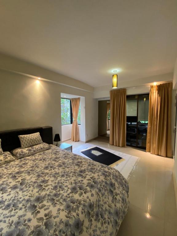 a large bedroom with a bed and a kitchen at KLCC Studio One Bedroom in Kuala Lumpur