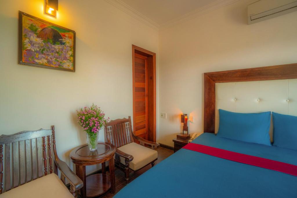 Llit o llits en una habitació de Calm House Hotel Hoi An 1