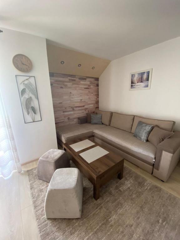 a living room with a couch and a coffee table at Apartman Zara Zlatar in Nova Varoš