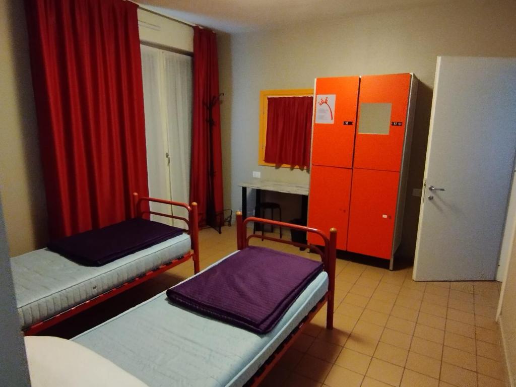 Postel nebo postele na pokoji v ubytování Ostello Torino