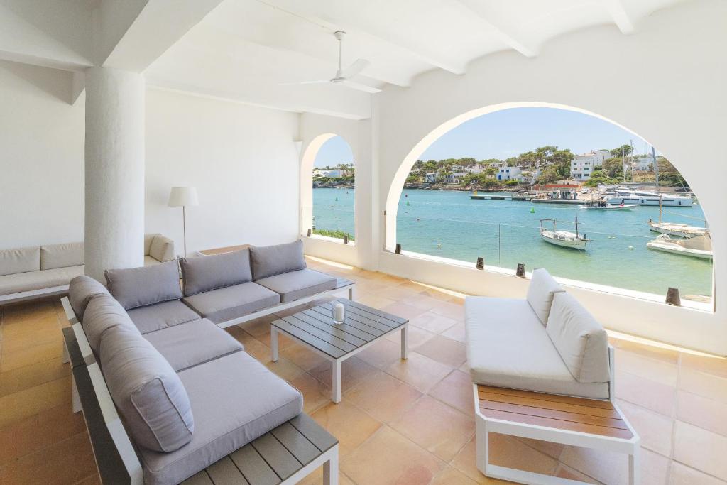 a living room with a couch and a view of the water at Villa Almar in Cala d´Or