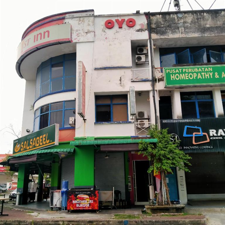 a building with a sign on the side of it at 1st Inn Hotel Glenmarie in Shah Alam