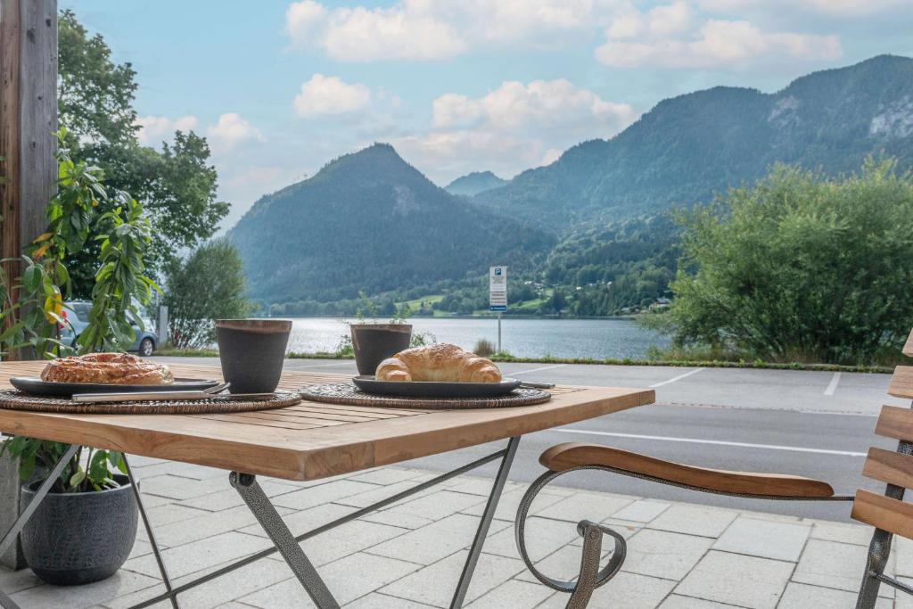a wooden table with two plates of food on it at Apartment am Grundlsee in Grundlsee