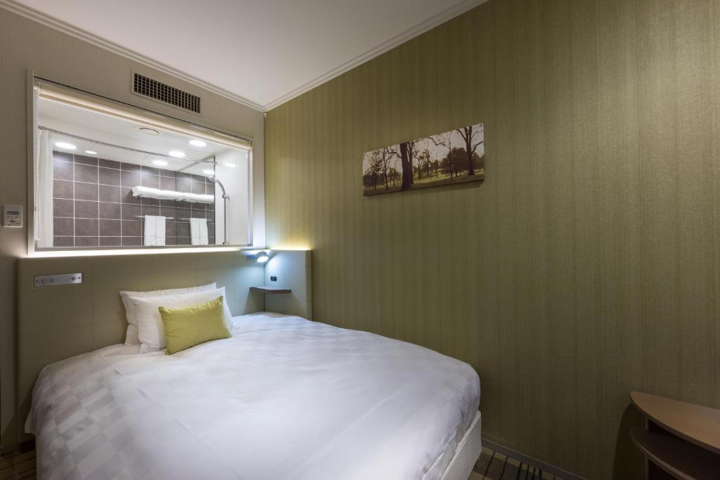 Postel nebo postele na pokoji v ubytování Kichijoji Excel Hotel Tokyu