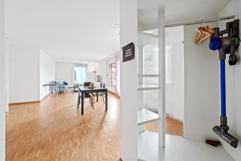 a living room with a staircase and a dining room at Spacious Central Apartments HOTING in Zürich