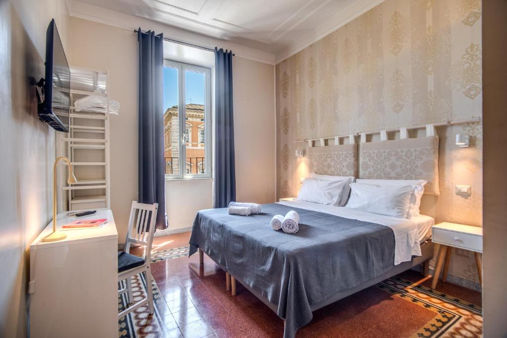 a bedroom with a large bed and a window at Casa Échelle in Rome