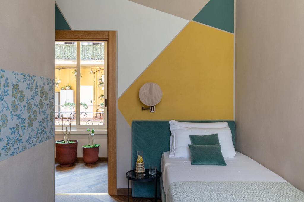 a bedroom with a bed and a window at Boutique Hotel Galatea in Rome