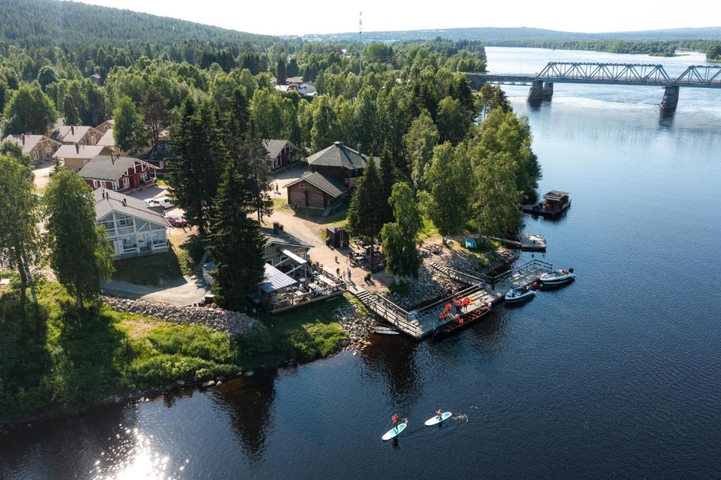 an aerial view of a small island in a river with boats at Lapland Hotels Ounasvaara Chalets in Rovaniemi