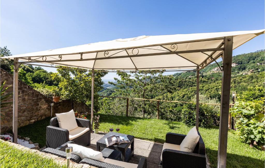a white canopy over a patio with chairs and a table at 3 Bedroom Stunning Home In Marliana in Marliana