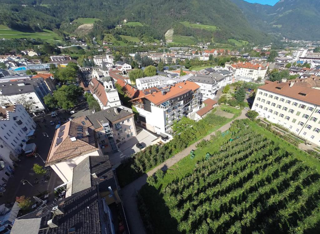 a small town with a large building on top of it at KRONE eat drink stay in Bressanone