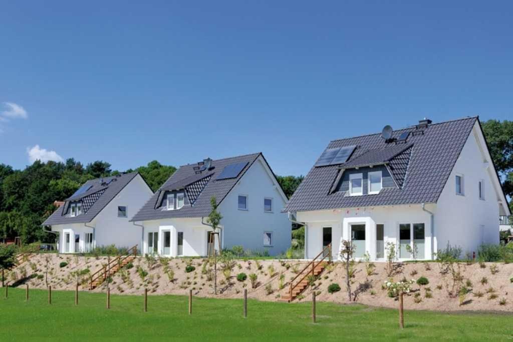 a row of houses with solar panels on their roofs at Ferienhaus Alt Sallenthin 10 B, "Sonne" in Neu Sallenthin