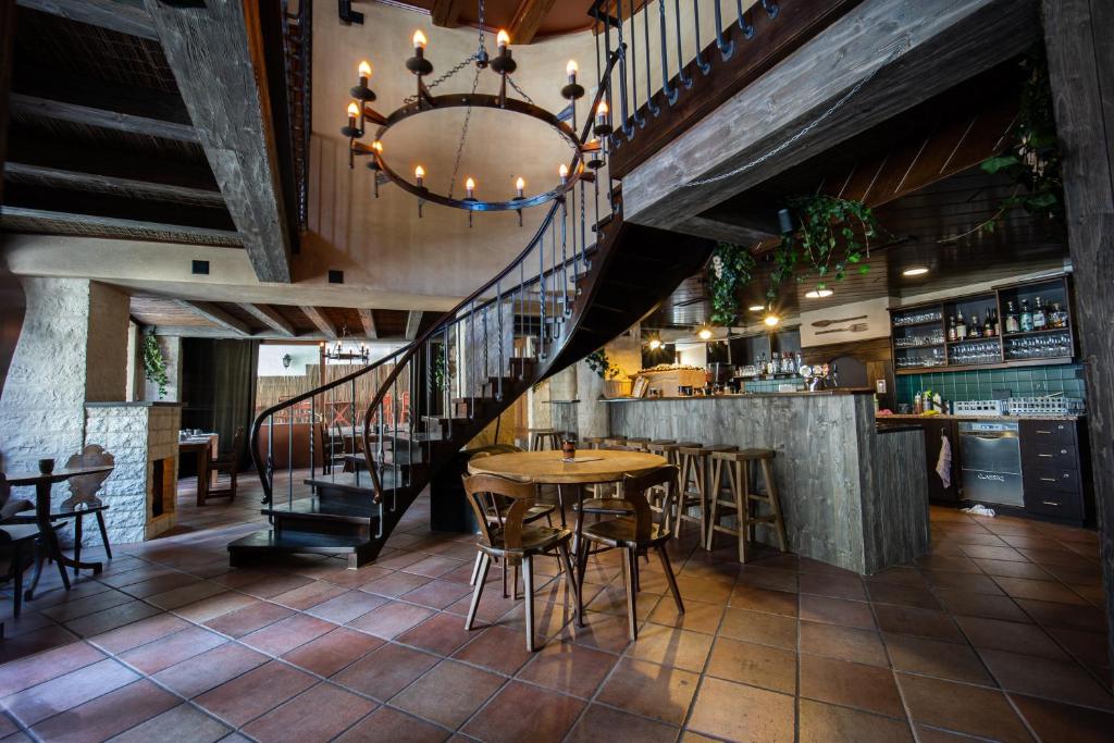 a restaurant with a table and chairs and a bar at Peanut Medieval Lodge in Saint-Ursanne