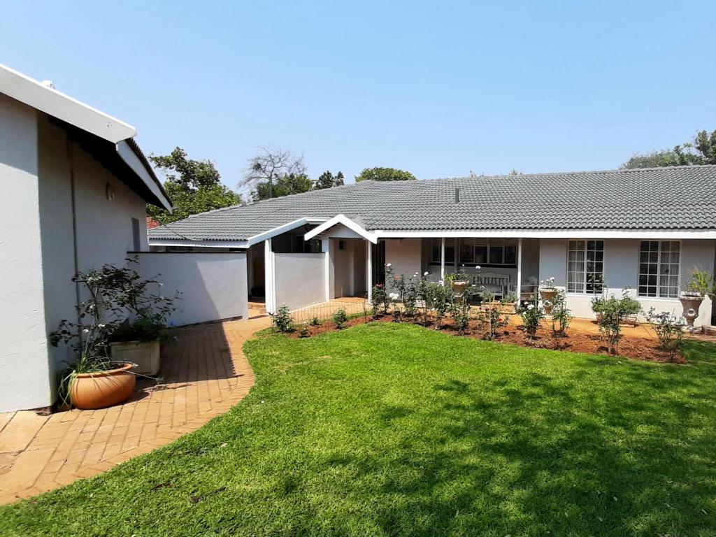 a house with a lawn in front of it at Kruger Southern Cross in Malelane