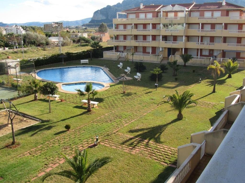 a view from the balcony of a hotel with a swimming pool at Apartment Deveses Park in Denia