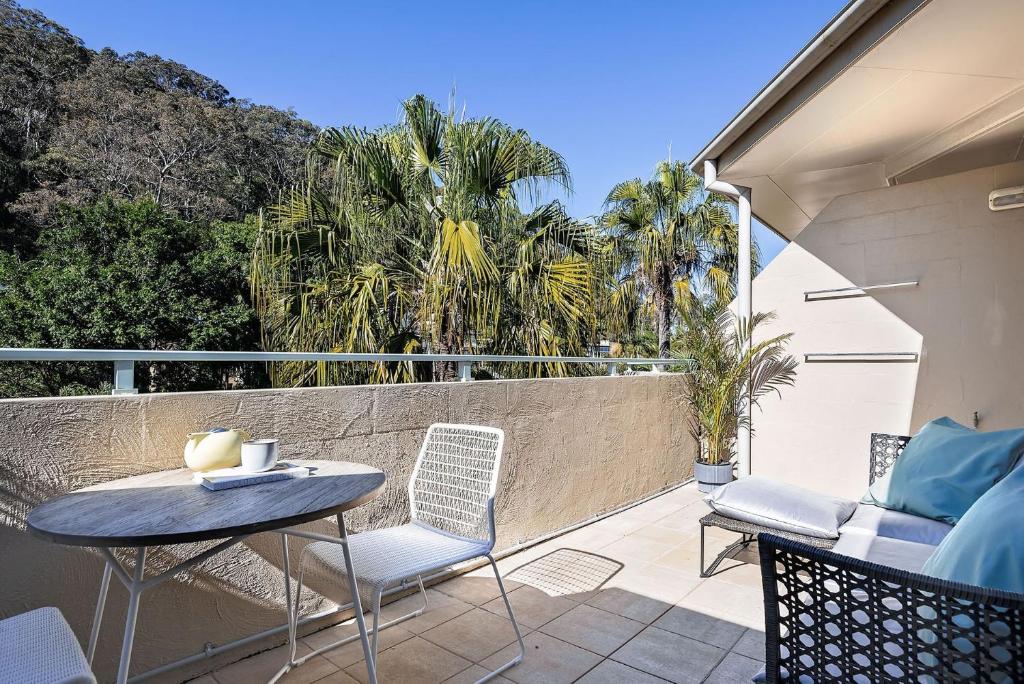 a patio with a table and chairs on a balcony at Oceans Eleven at Iluka Resort Apartments in Palm Beach