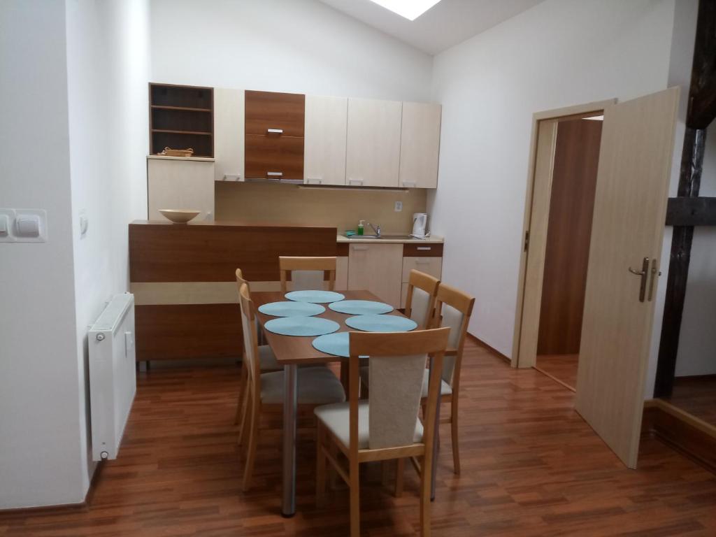 a kitchen and dining room with a table and chairs at Apartmány Liptov in Liptovský Mikuláš