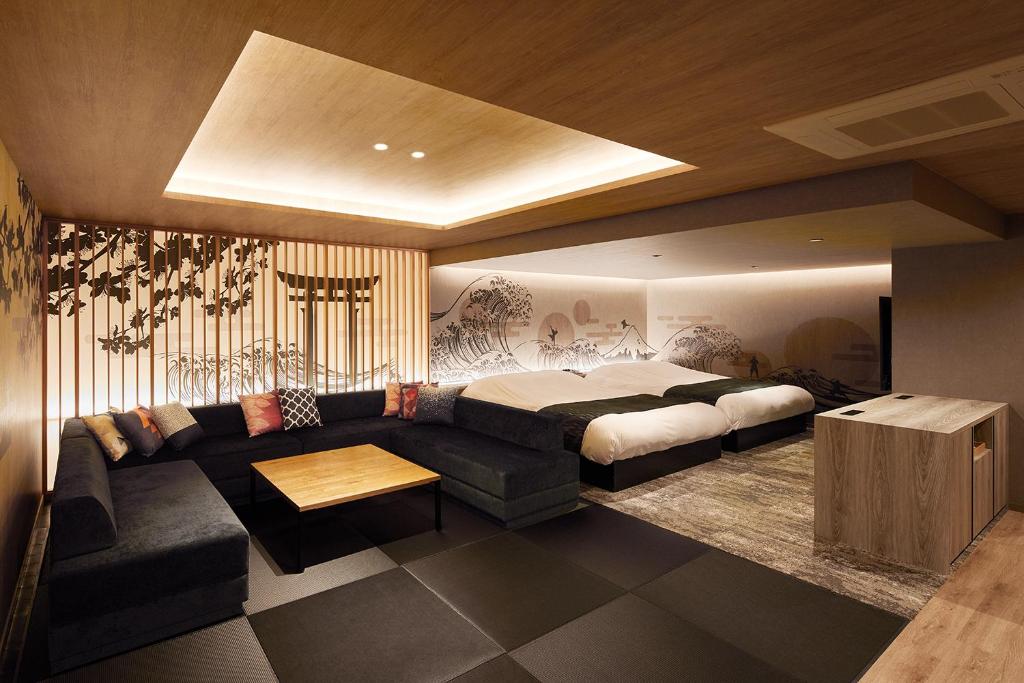 uma sala de estar com uma cama e um sofá em Yatomi Hotel Nuqu Natural Hot Spring 