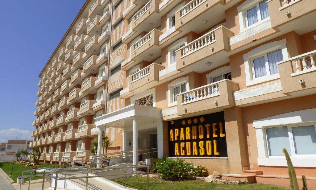 a large apartment building with a sign on it at Aparthotel Acuasol in Peniscola