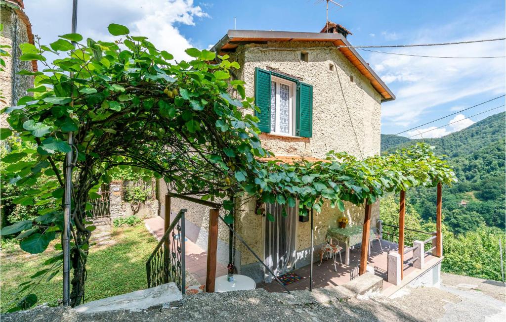 a small stone house with a green window at Casa Andrea in Culla