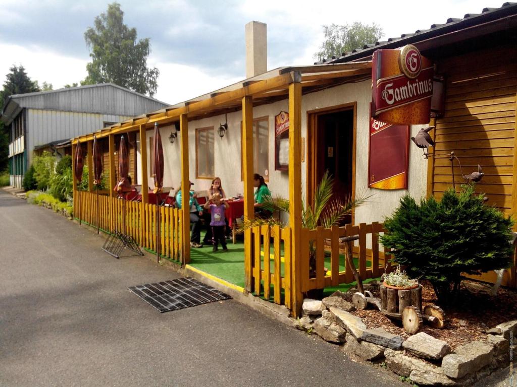 a restaurant with people sitting inside of a train at Penzion Na Srubech in Hora Svaté Kateřiny