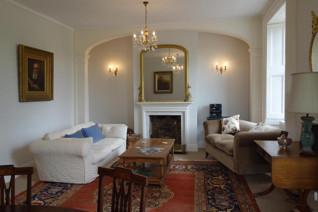 a living room with two couches and a fireplace at The East Wing in Glasbury