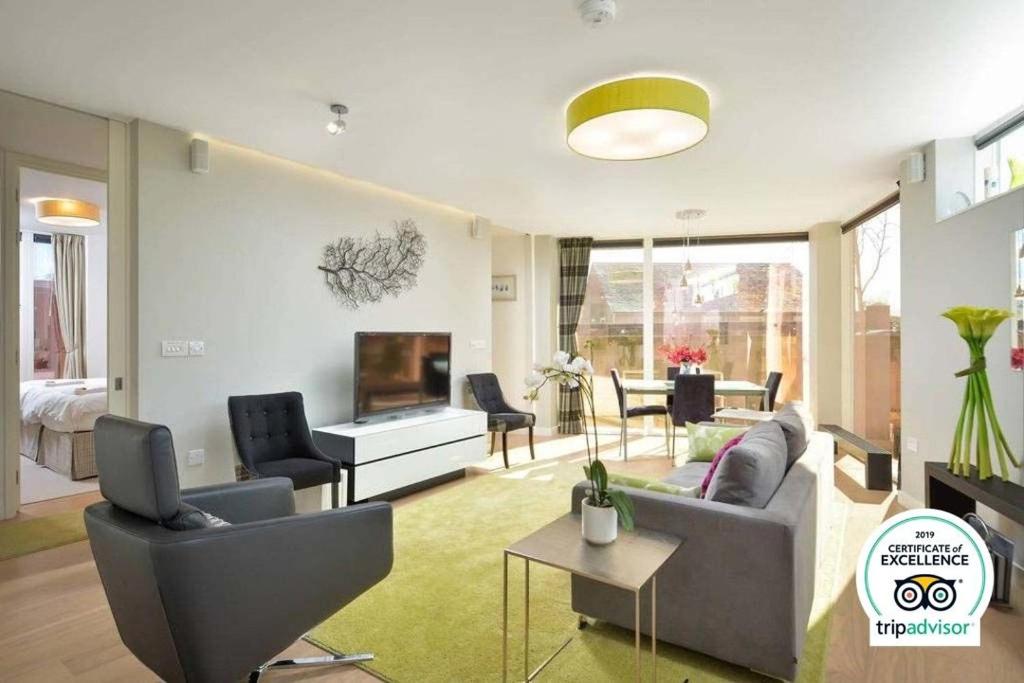 a living room with a couch and a tv at The Golf Flat, Westburn Lane in St. Andrews