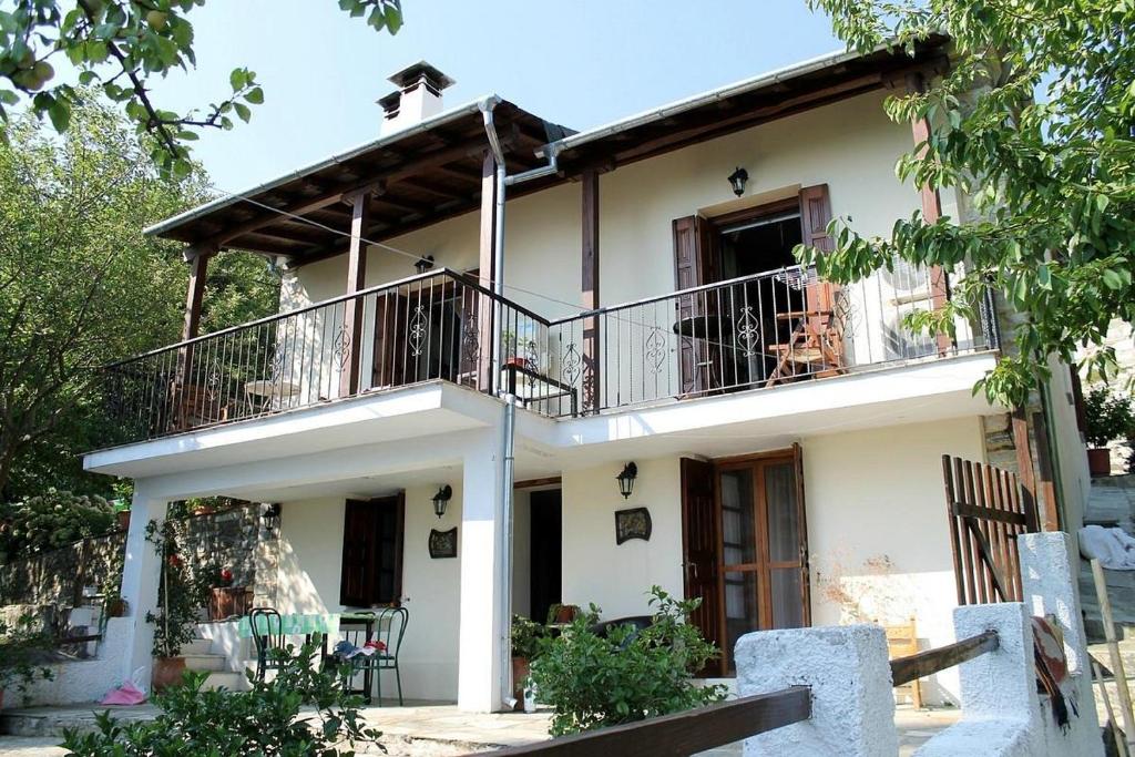 a large white house with a balcony on top at Kleopatras 2 in Tsagarada