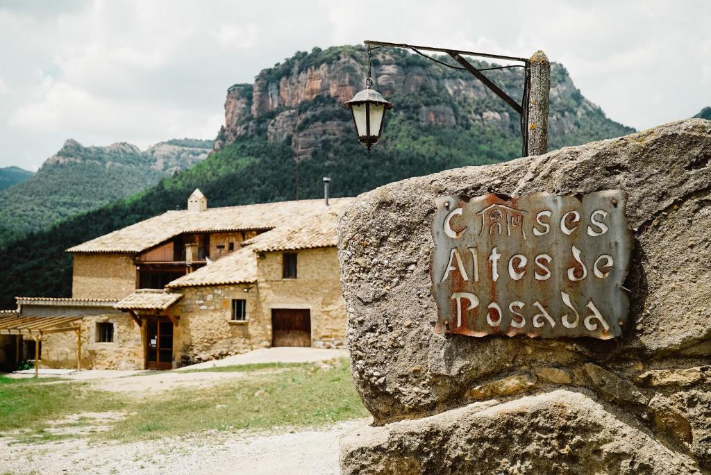 a sign on a rock in front of a building at Cases Altes de Posada in Navés