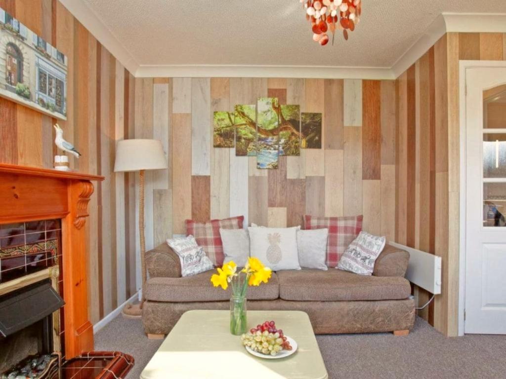 a living room with a couch and a table at Dawlish Warren Holidays in Dawlish
