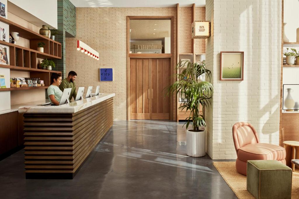 two people sitting at a counter in a lobby at The Hoxton, Poblenou in Barcelona