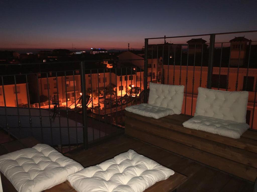 two white pillows sitting on top of a balcony at VILLA CARLOTTA GRADO in Grado
