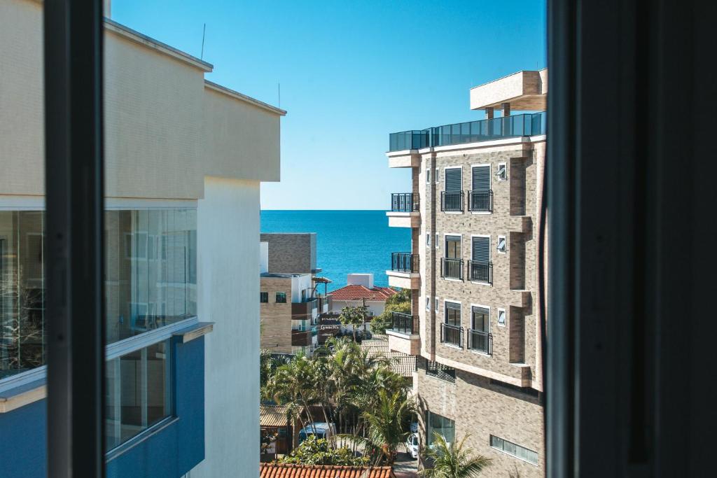 a view of the ocean from a window at temporadabombinhas 2 suítes in Bombinhas