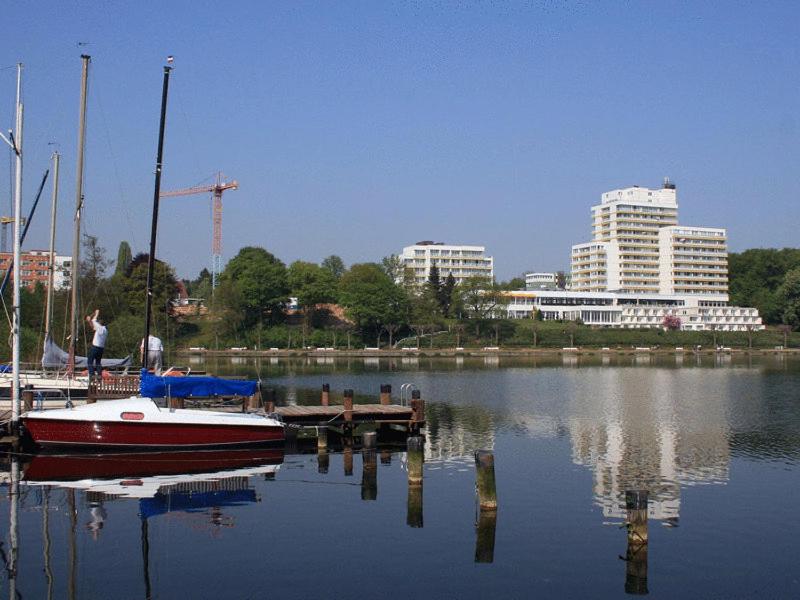 a boat is docked at a dock in the water at Vitalia Seehotel in Bad Segeberg