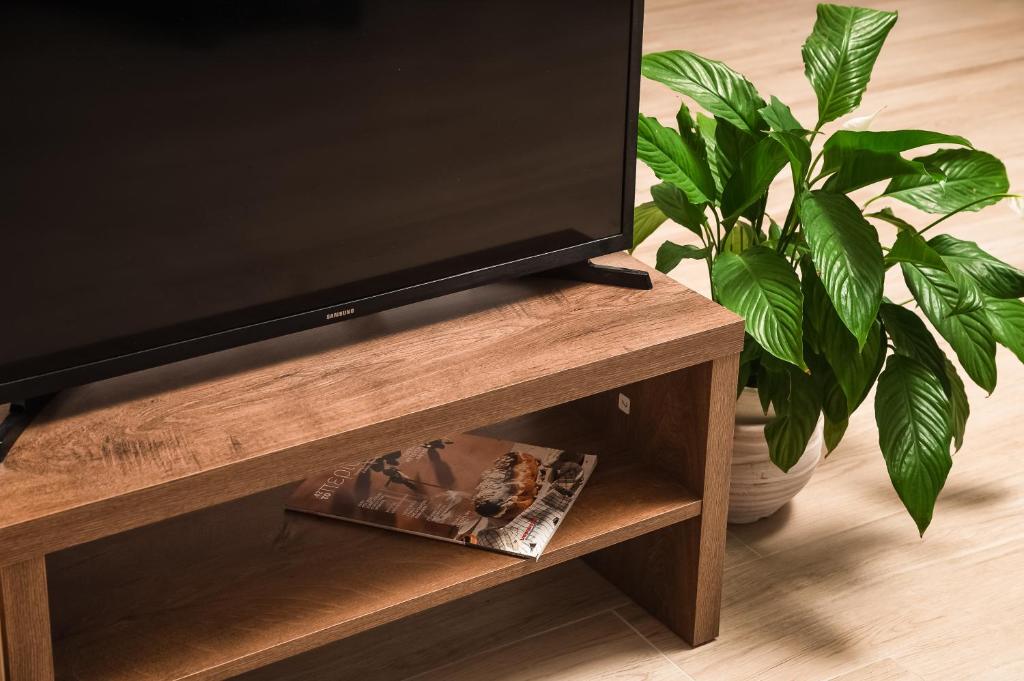 A television and/or entertainment centre at ModernPastel Apartment - Private Parking,Near the Old Port