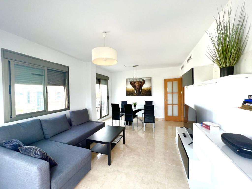 a living room with a couch and a table at Atico Oliva Nova - MET in Oliva